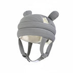 Gray helmet with ear-like features on a light blue background