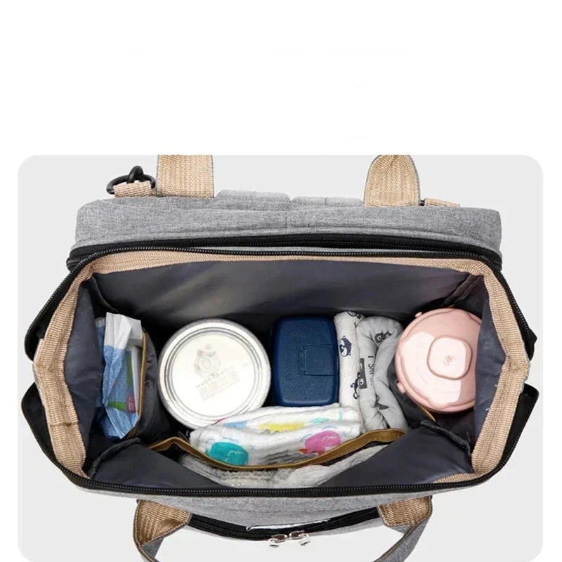 Open diaper bag with organized items on a white background