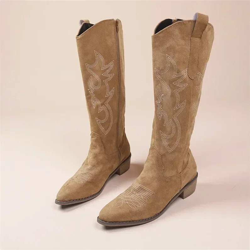 Women's knee-high cowboy boots with colorful embroidery accents.